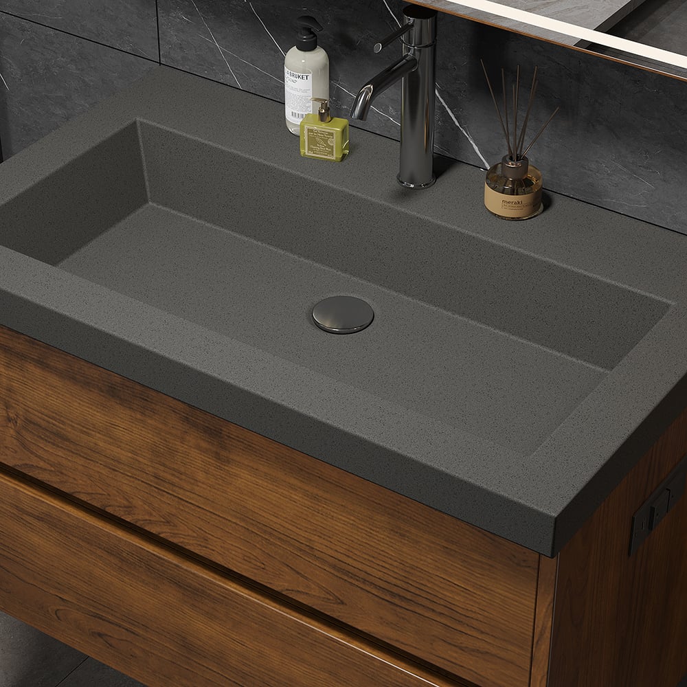 Bathroom sink with dark gray countertop and wooden cabinet