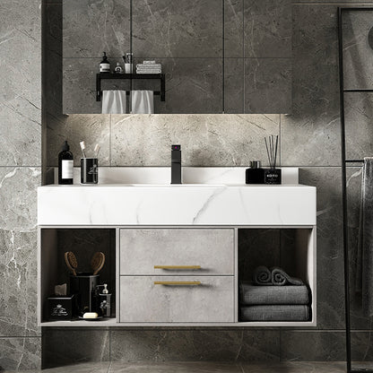 Bathroom vanity with marble countertop and gray tiles on the wall.