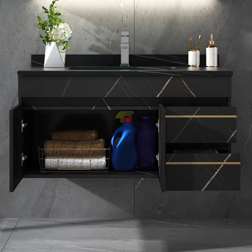 Black bathroom vanity with open cabinet doors showing cleaning supplies against a gray marble wall.