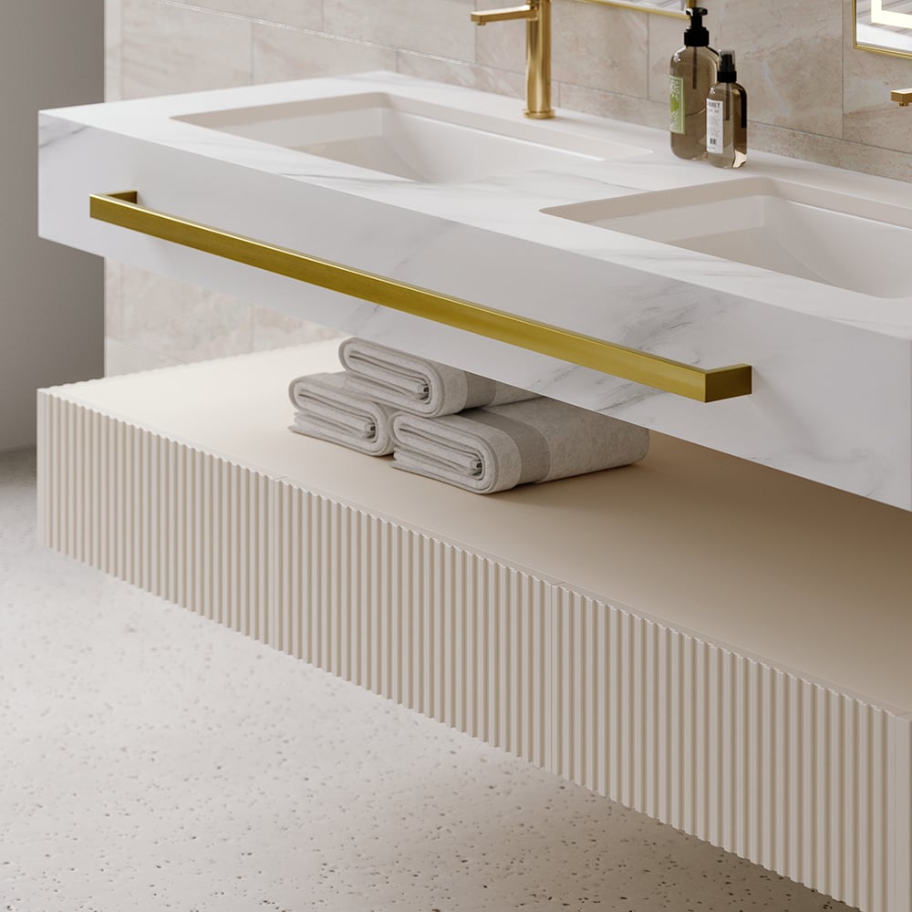 Bathroom vanity with white countertop, gold handle, and folded towels.