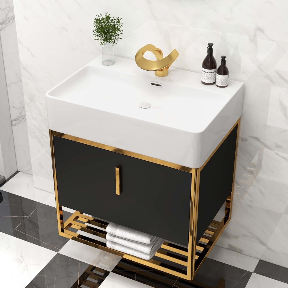 Bathroom vanity with white sink, black cabinet, and gold accents.