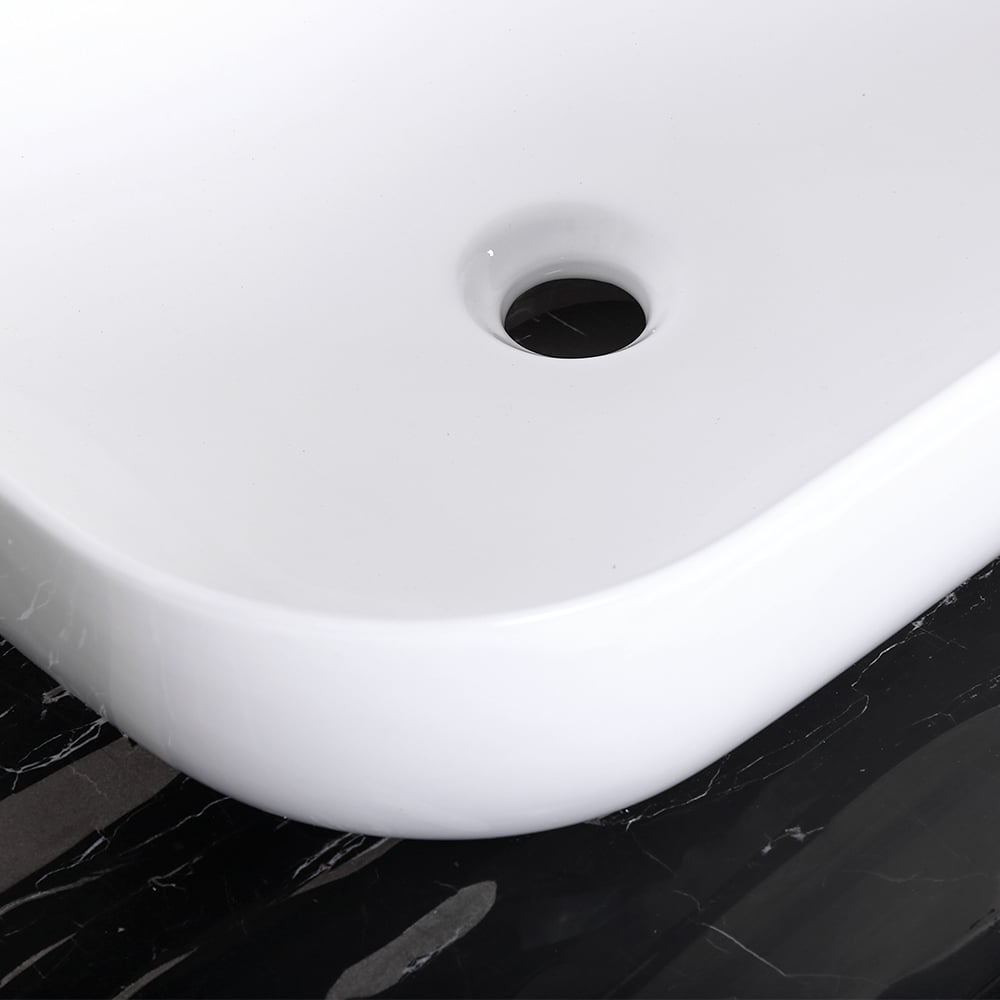 White ceramic sink basin on a black marble countertop