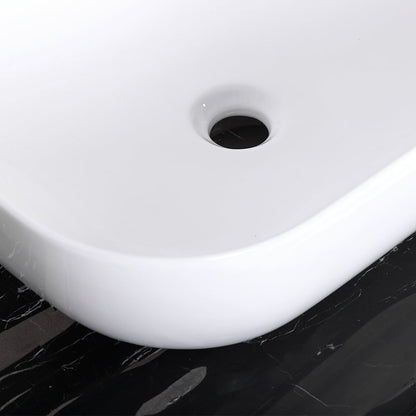 White ceramic sink basin on a black marble countertop