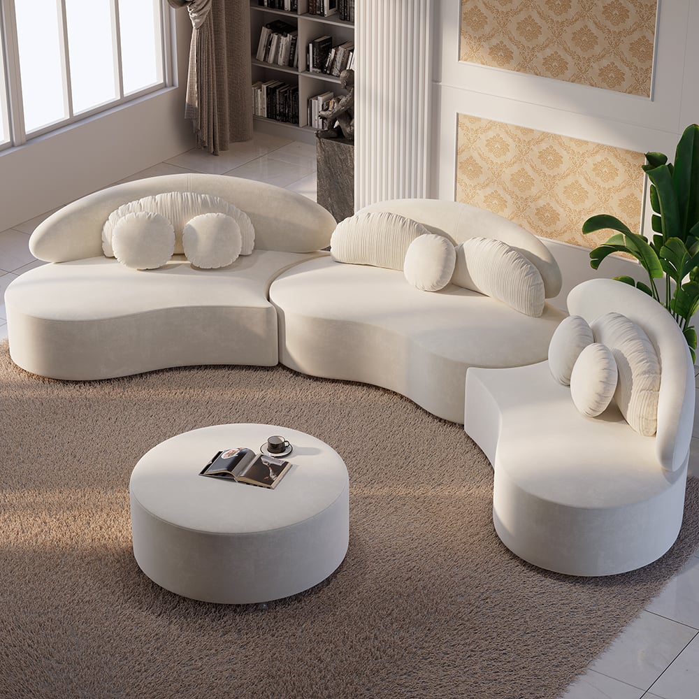 Modern white sectional sofa with round ottoman in a living room setting.