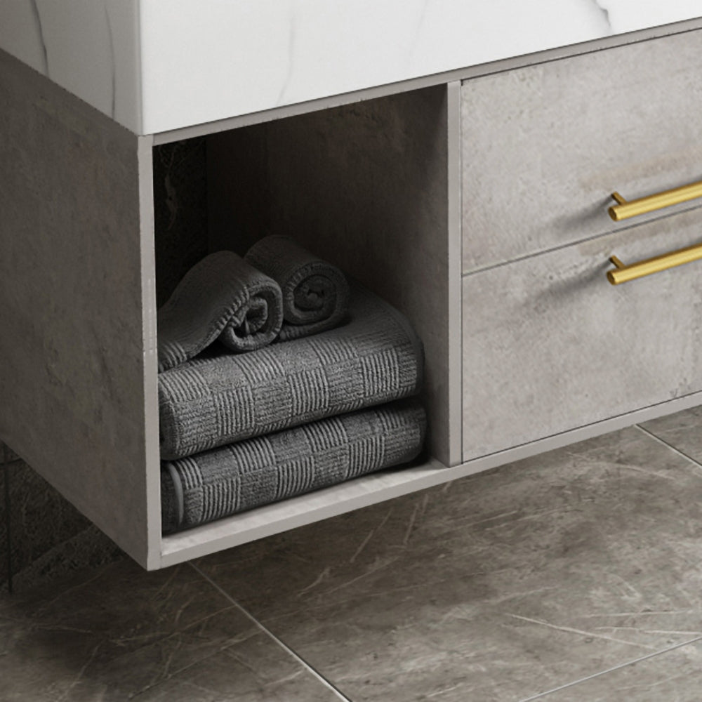 Bathroom cabinet with folded towels inside, featuring gold handles.