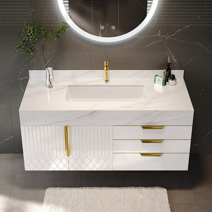 Bathroom vanity with marble countertop, sink, and gold fixtures against a gray wall.