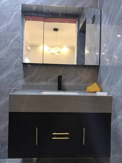 Bathroom vanity with mirror and sink against a gray marble wall