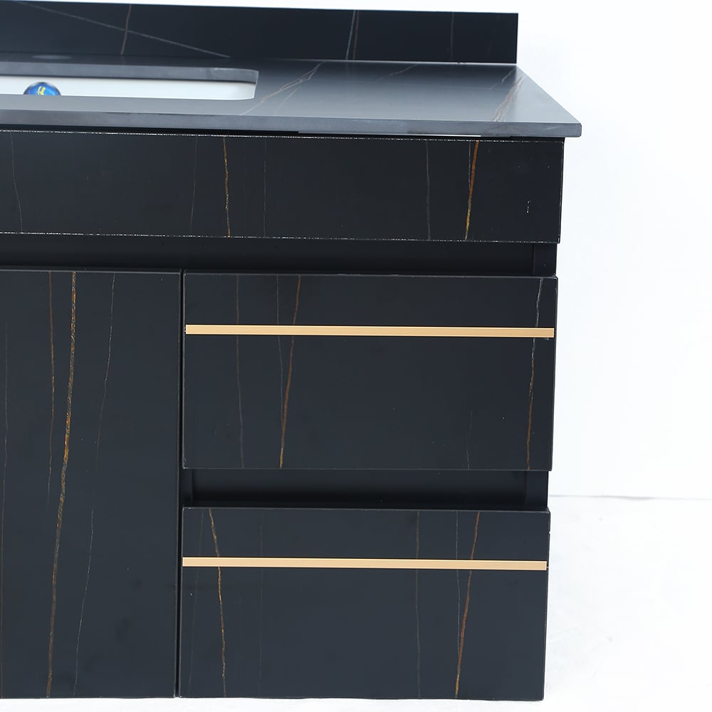 Black bathroom vanity with gold accents on a white background