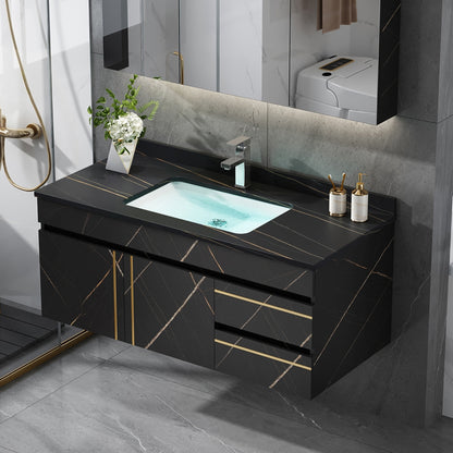 Bathroom vanity with black marble countertop and sink, featuring gold accents.