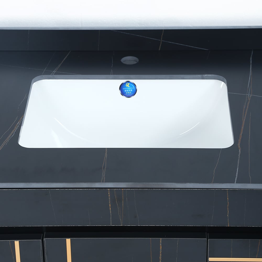 Rectangular white sink on a black tiled wall