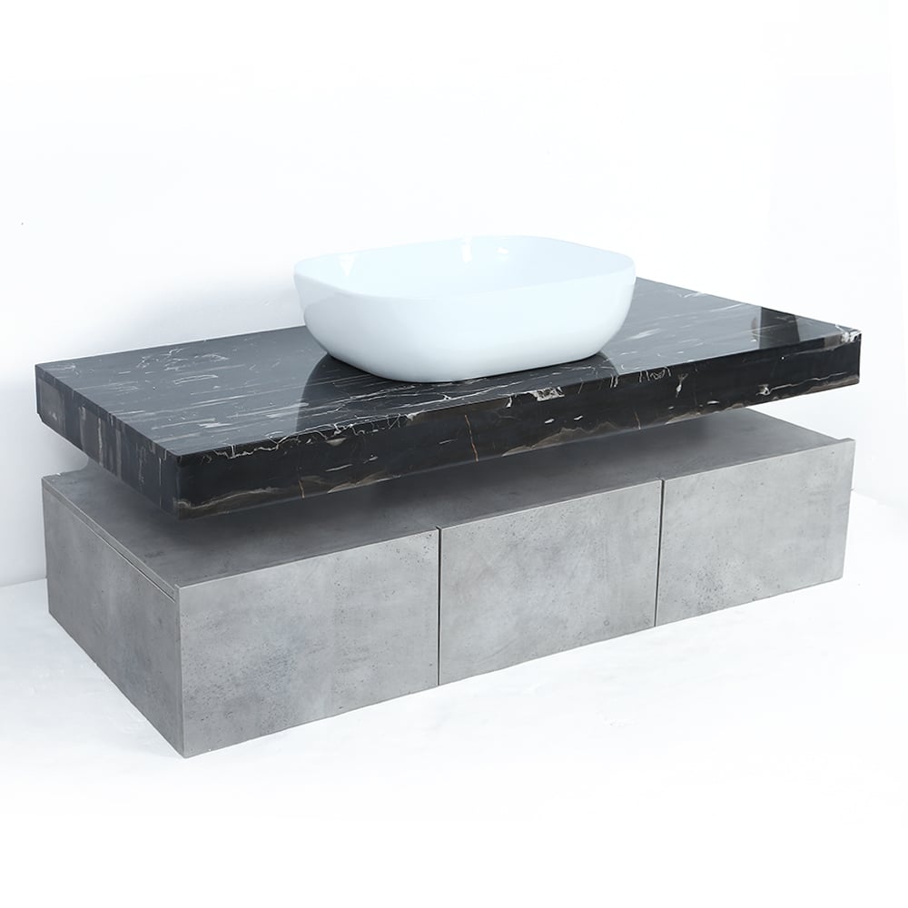 Bathroom vanity with black marble countertop and white sink on a white background