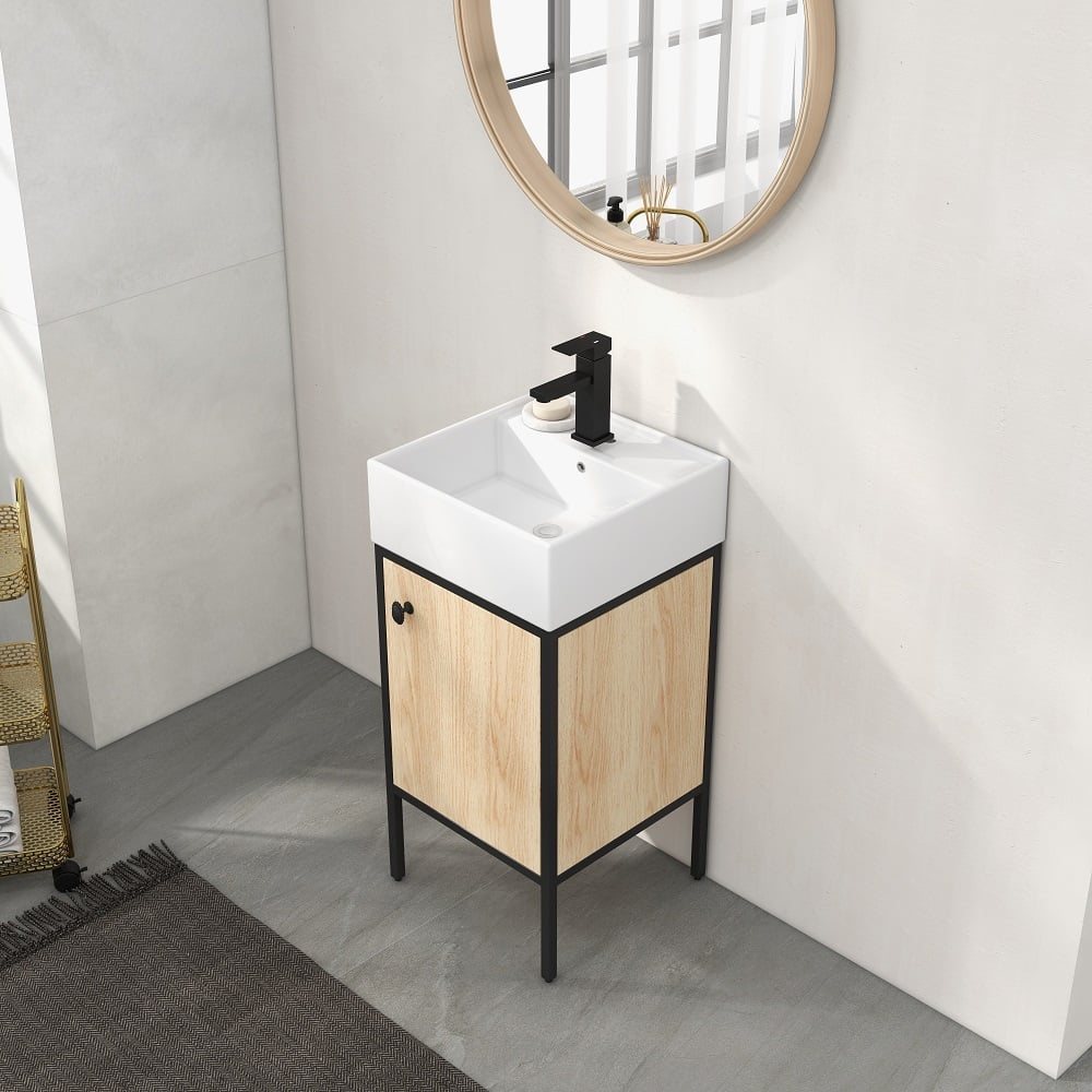 Bathroom vanity with white sink and wooden cabinet against a white wall.