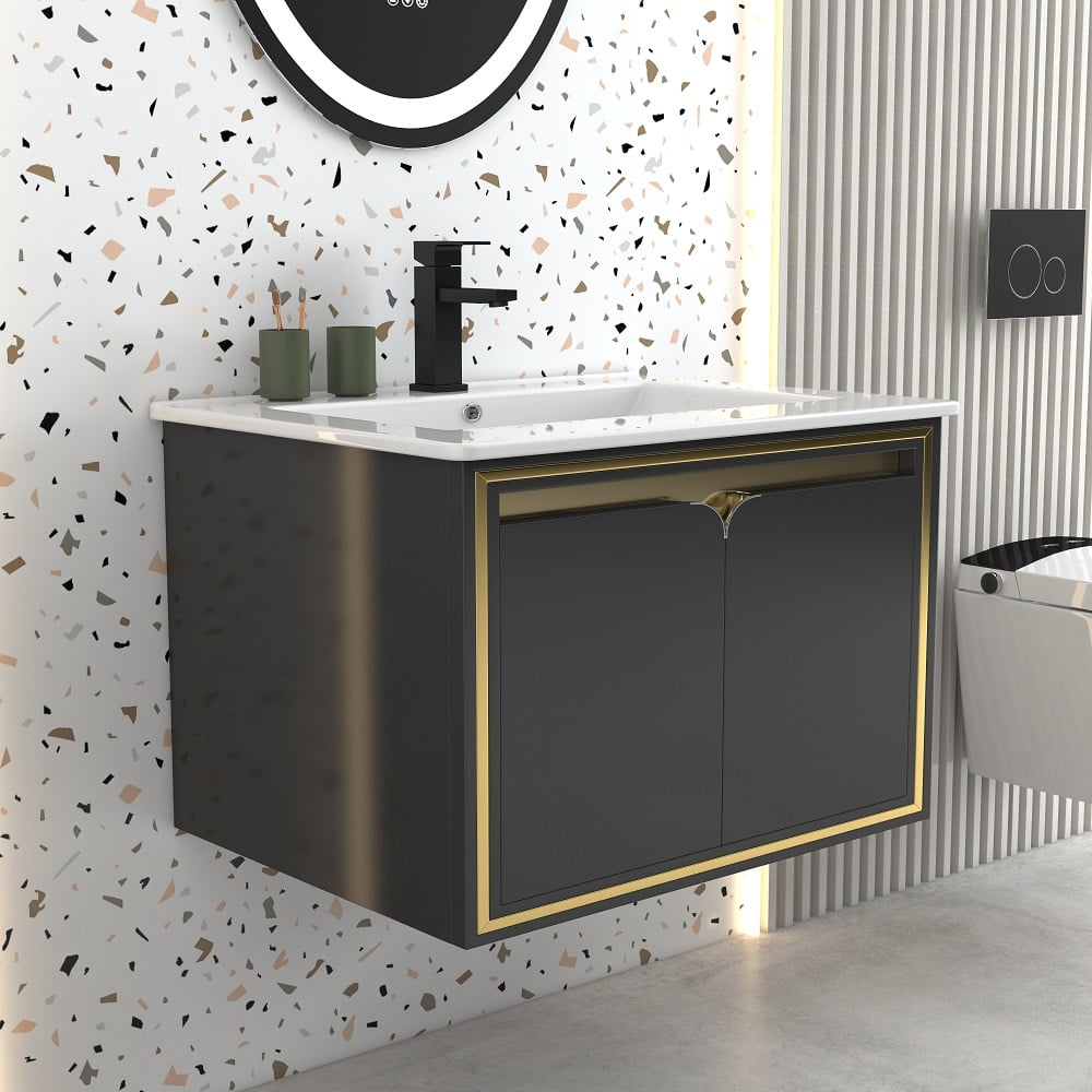 Bathroom vanity with black and gold cabinet, white countertop, and decorative wall tiles.