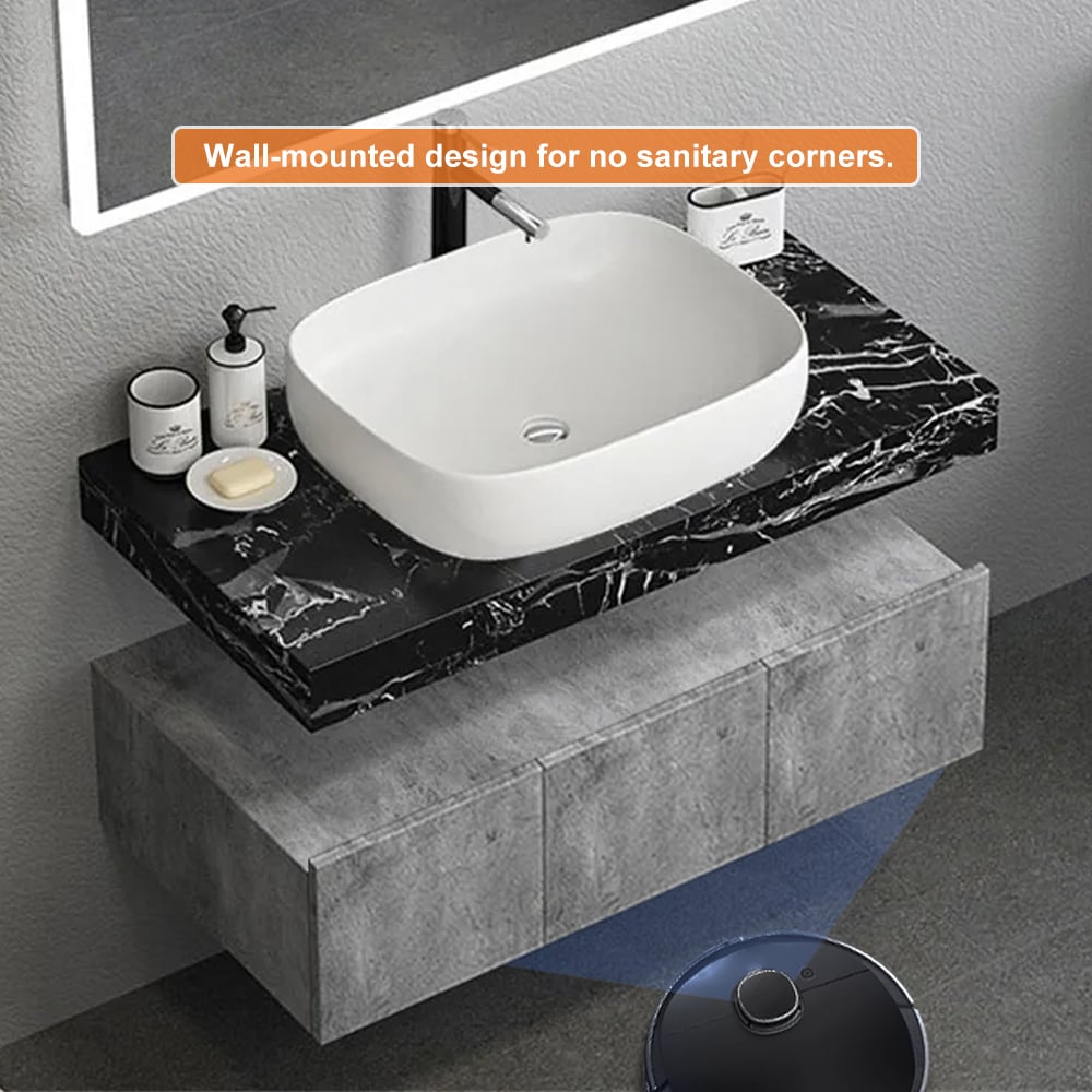 Wall-mounted bathroom sink with black marble countertop and concrete base.