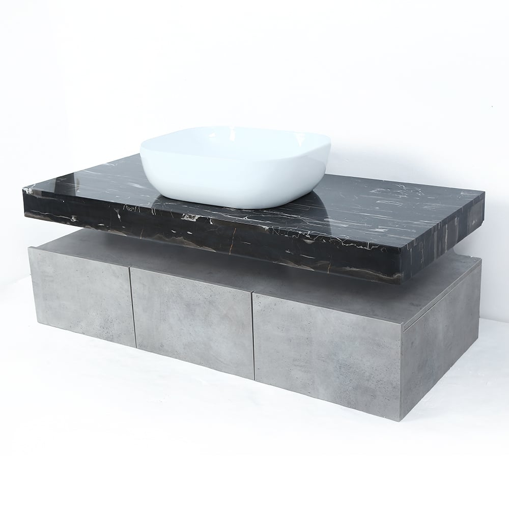 Bathroom vanity with black marble countertop and white sink.