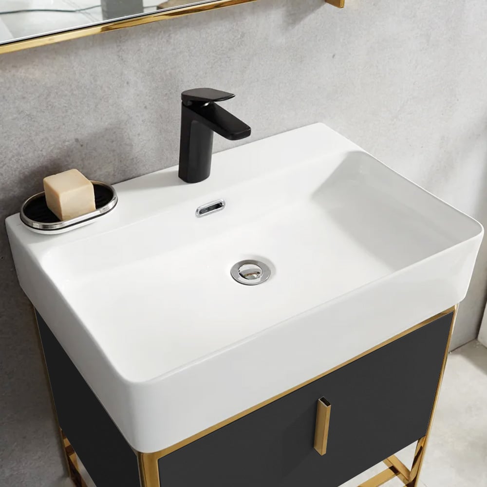 White sink with black faucet and soap on a gray countertop