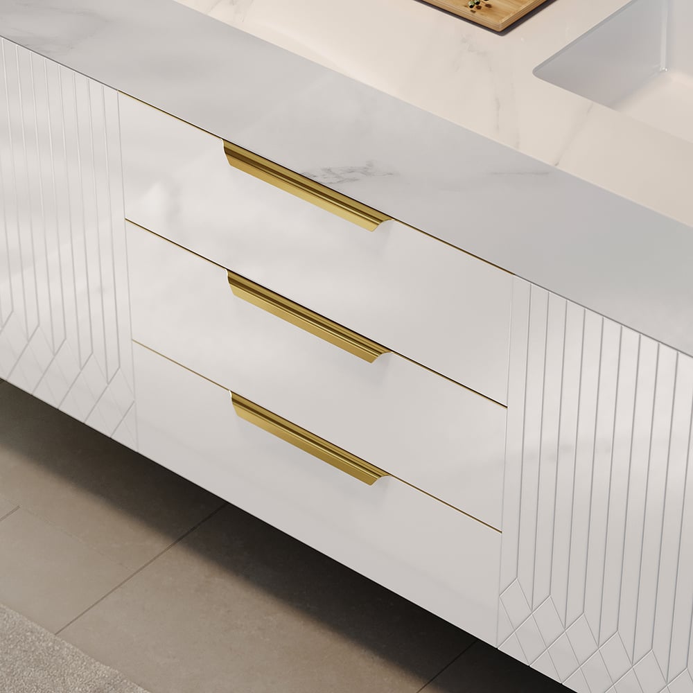 White kitchen cabinets with gold handles on a tiled floor.