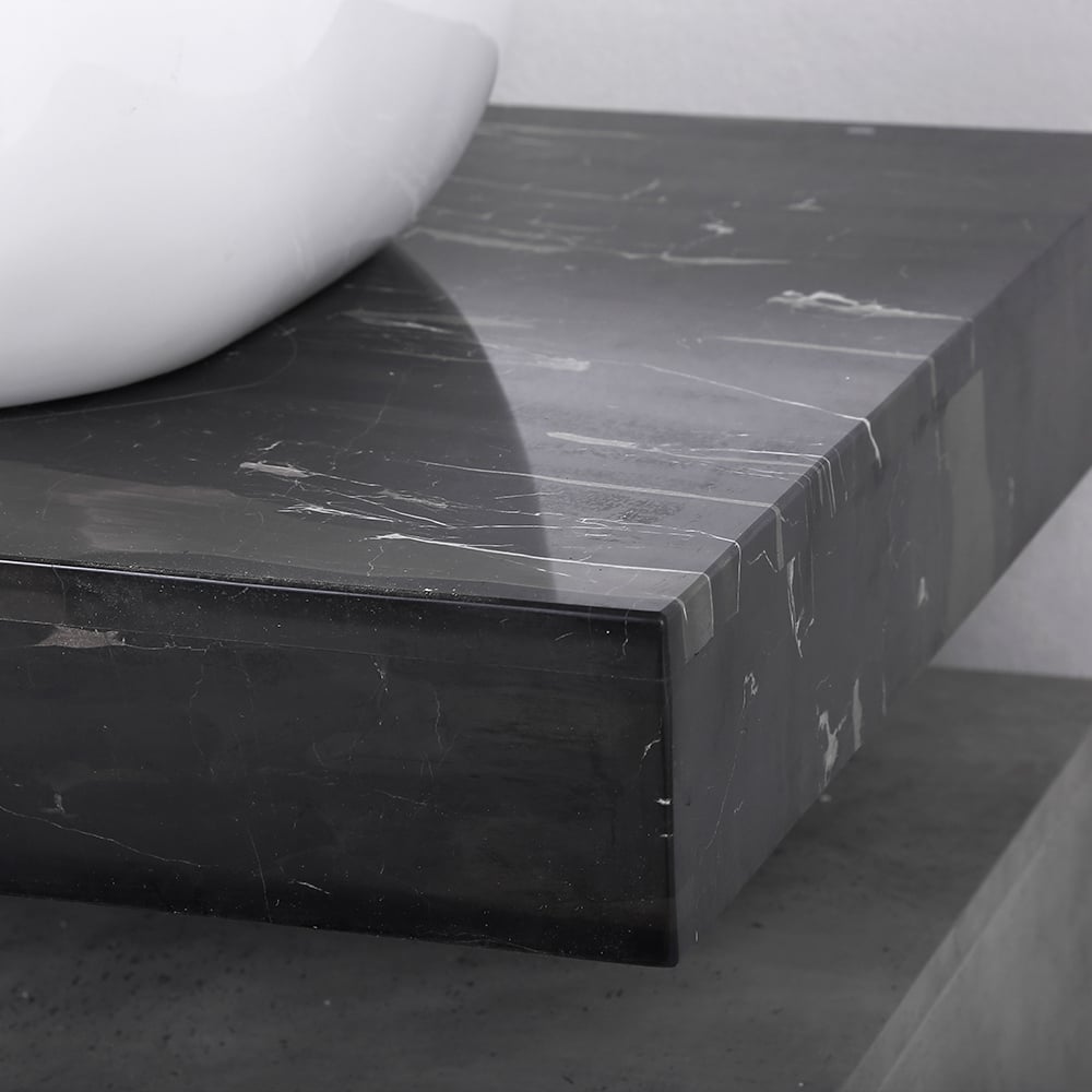 Black marble countertop with a white sink on a neutral background