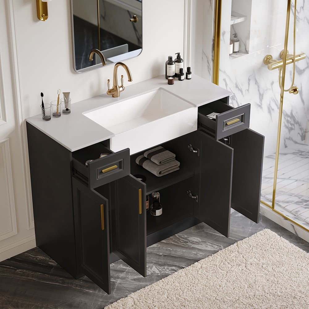 Bathroom vanity with open drawers, sink, and gold fixtures.