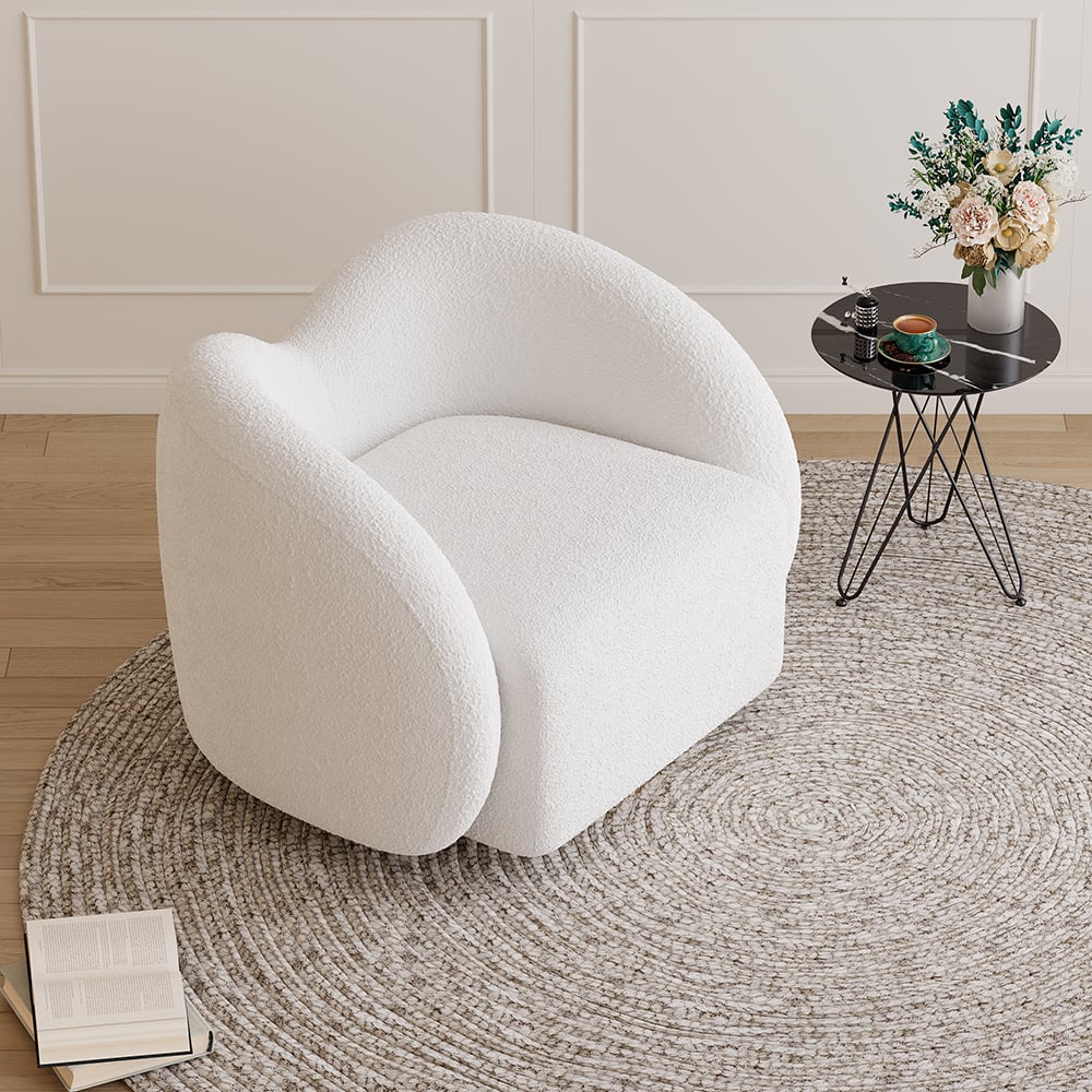 White armchair in a room with a small table and flowers