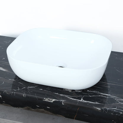 White ceramic sink on a black marble countertop