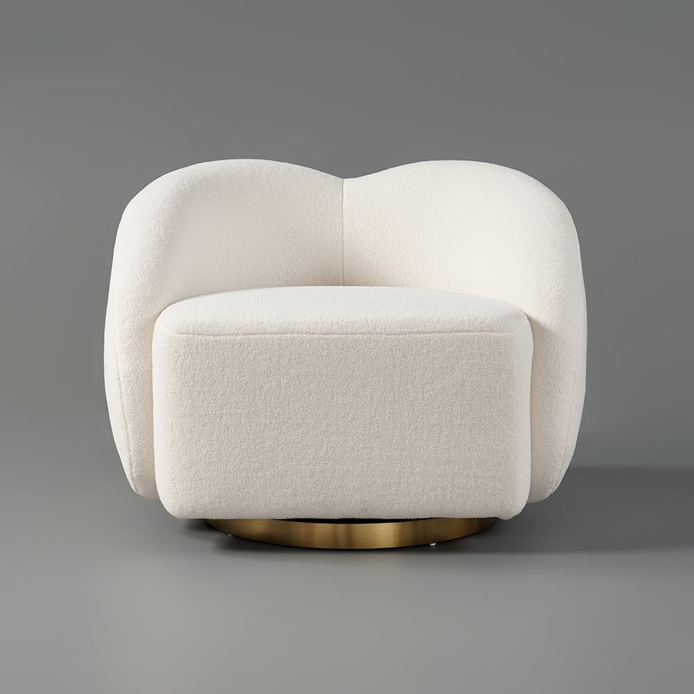 Modern cream armchair with gold base on a gray background