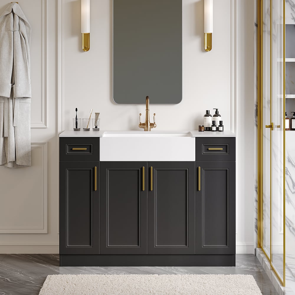 Bathroom with dark gray vanity, white sink, and gold fixtures.