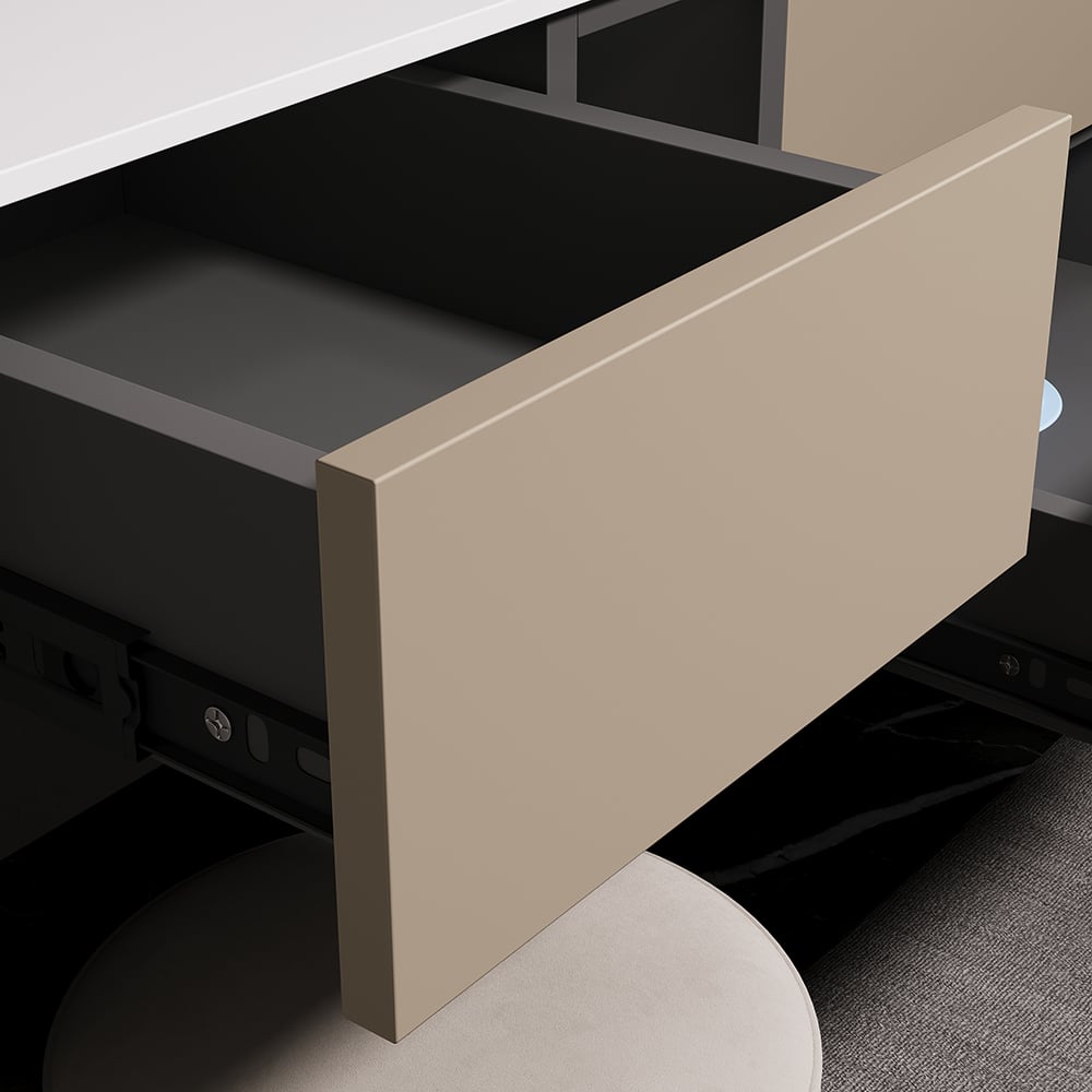 Open beige drawer in a desk setup with a computer monitor in the background